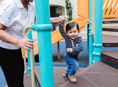 little boy on playground with woman